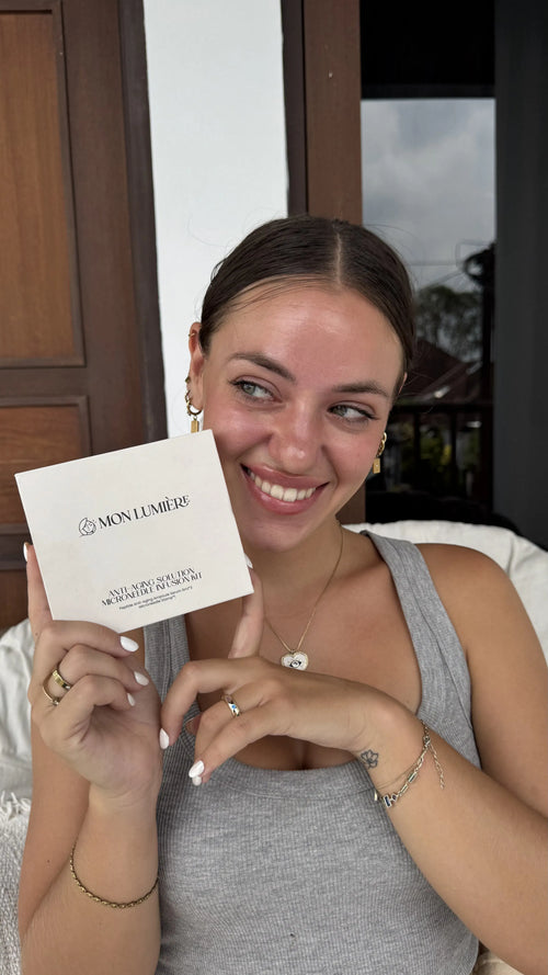 Woman holding a Mon Lumier product box outdoors