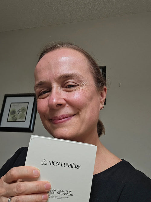Person holding a Mon Lumiere skincare product box against a neutral background
