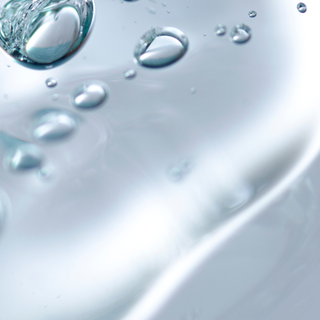 Close-up of water droplets on a surface with a blurred background